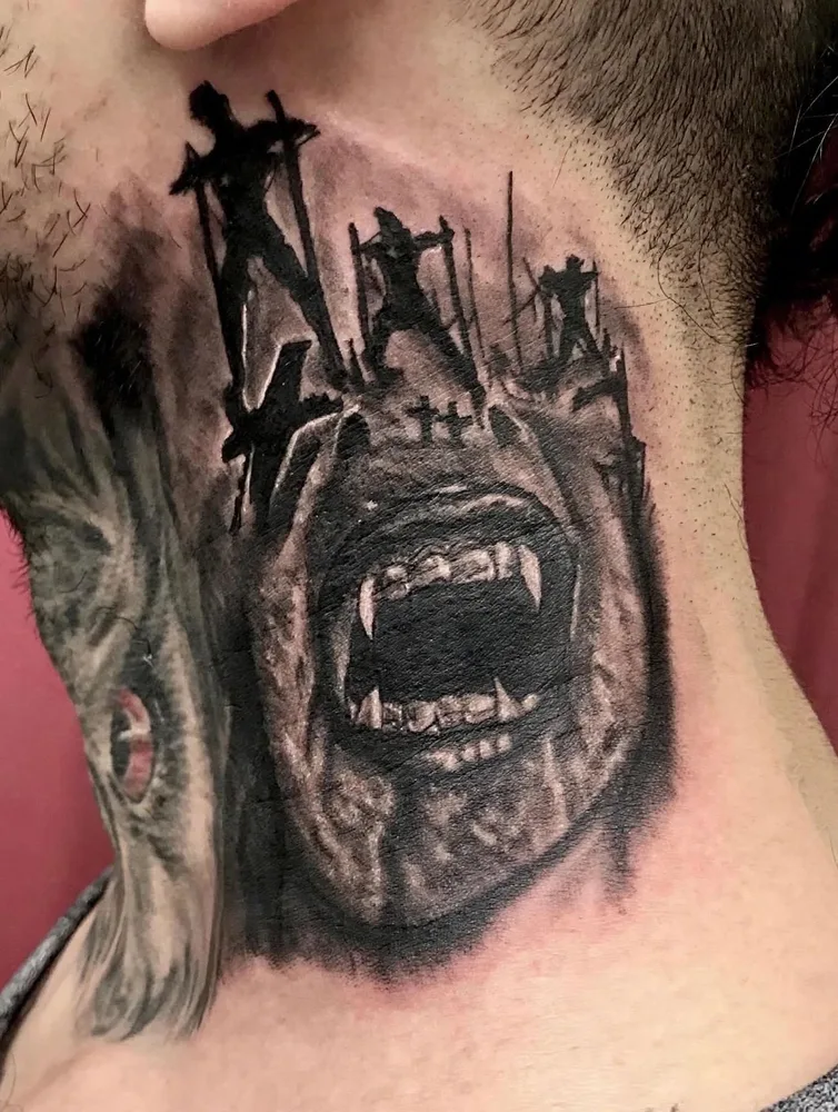 Dark art black and grey neck tattoo of a screaming vampire with fangs beneath a battlefield of crucified figures, horror style by Ivan Todorov at N9 Tattoo, Edmonton, North London